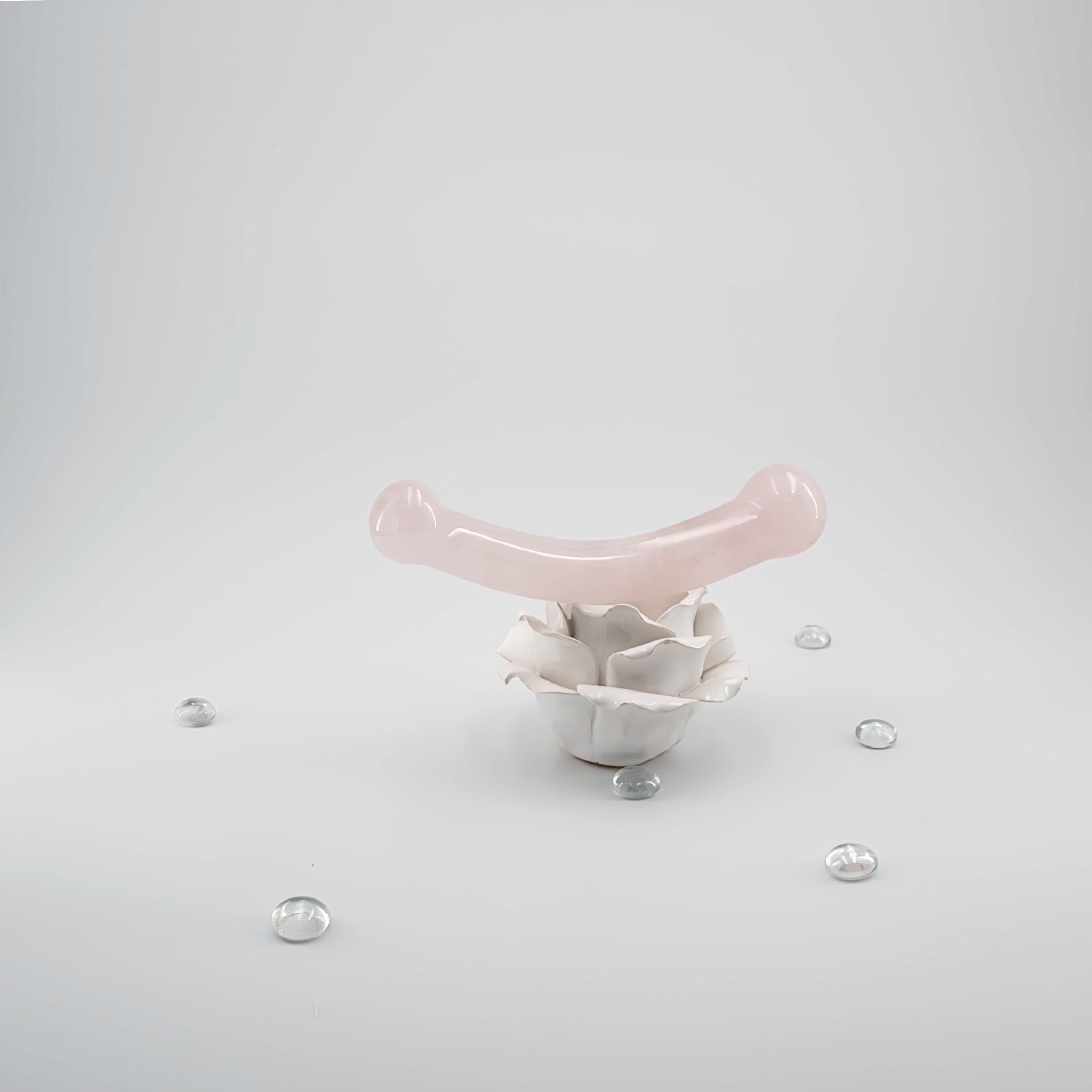 Crystal wand for G-spot stimulation displayed with decorative elements on a minimalist background.